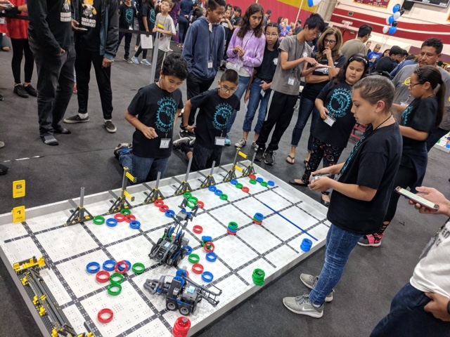 Photo of kids playing with robots
