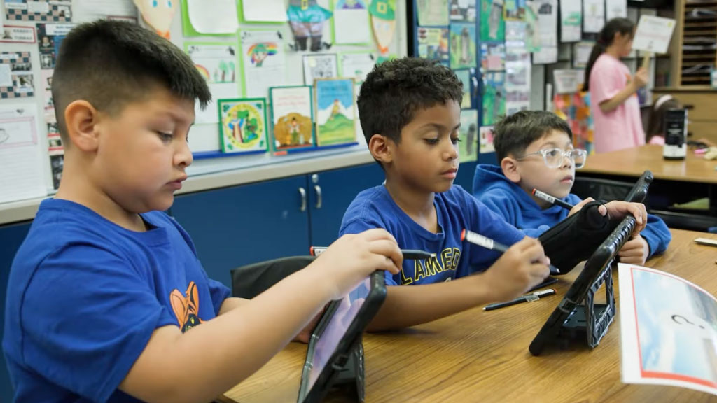 Students in the classroom using iPads
