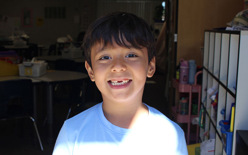 cute boy smiling in classroom