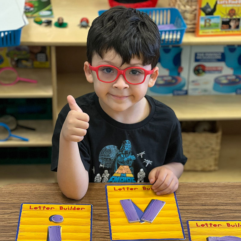 little boy giving a thumbs up