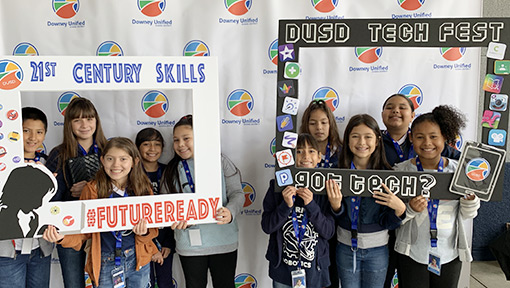 Elementary students holding technology skills signs