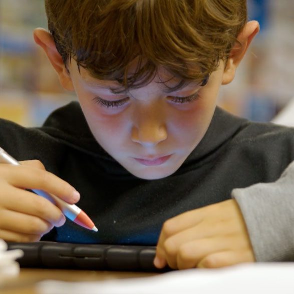 Boy studying on an iPad
