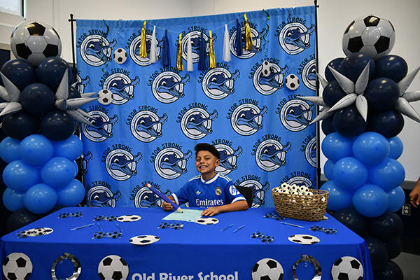 little boy on signing day at old river