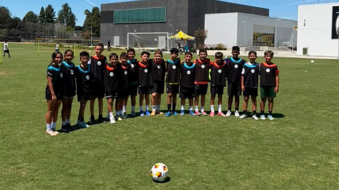 soccer team posing on the field