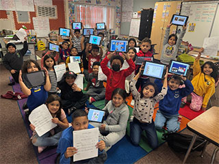 Student showing off projects in classroom