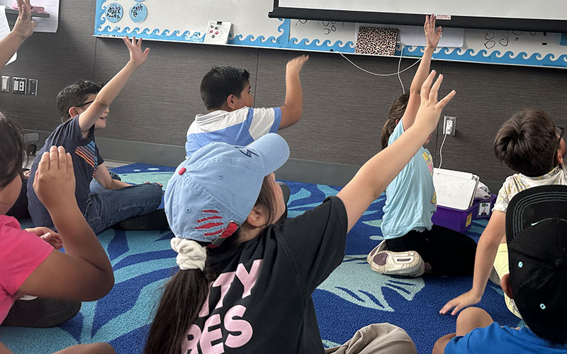 raising hands in classroom