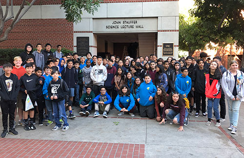 Group of GATE Program students standing in front of the Science Lecture Hall