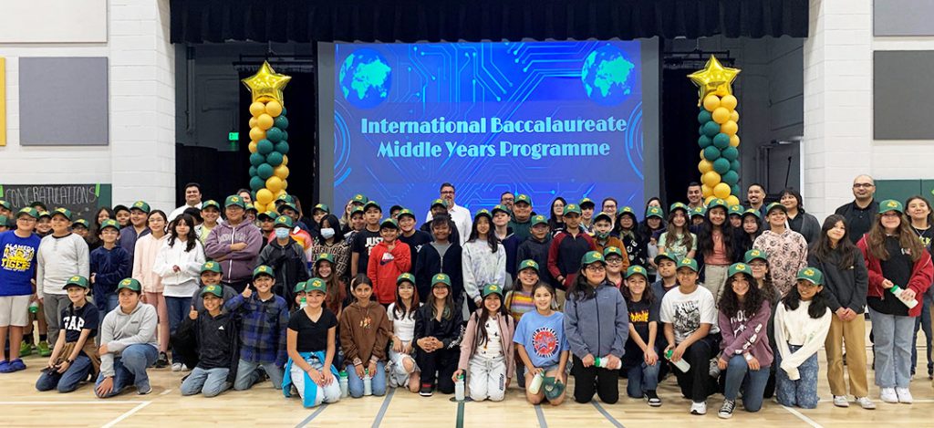 Students in front of a sign that says International Baccalaureate Middle Years Programme