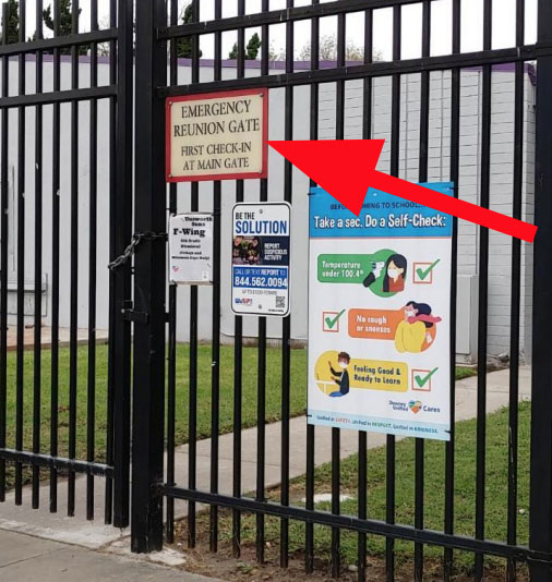 Emergency Reunion gate with sign saying to check in at the main gate first.