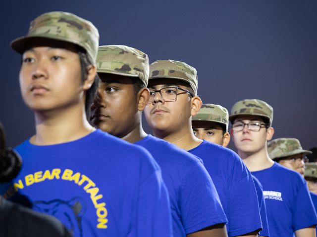 JROTC boot camp team moving a large tire