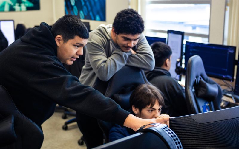 three students working on a gaming project