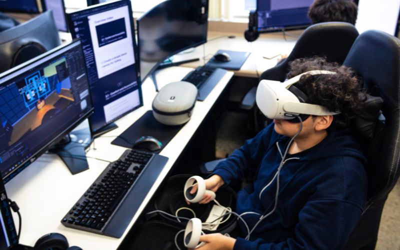student using virtual reality gaming equipment