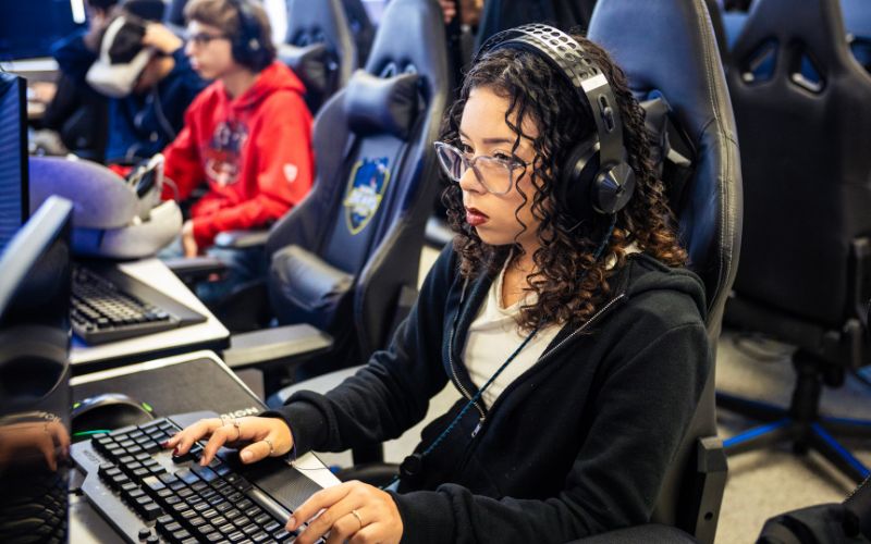 high school girl programming a video game