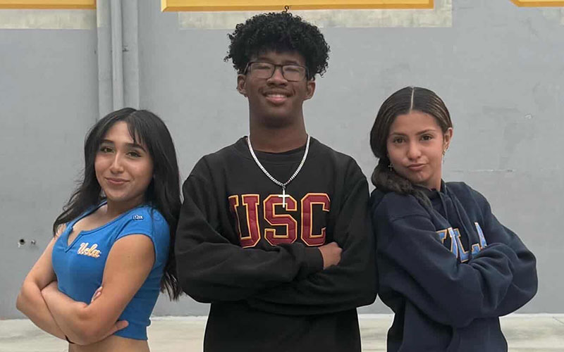 students posing in college gear
