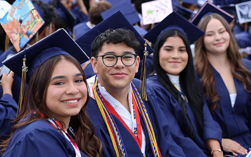 happy grads in gowns