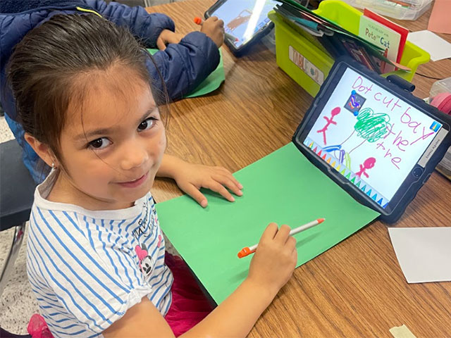 Young girl drawing on an iPad