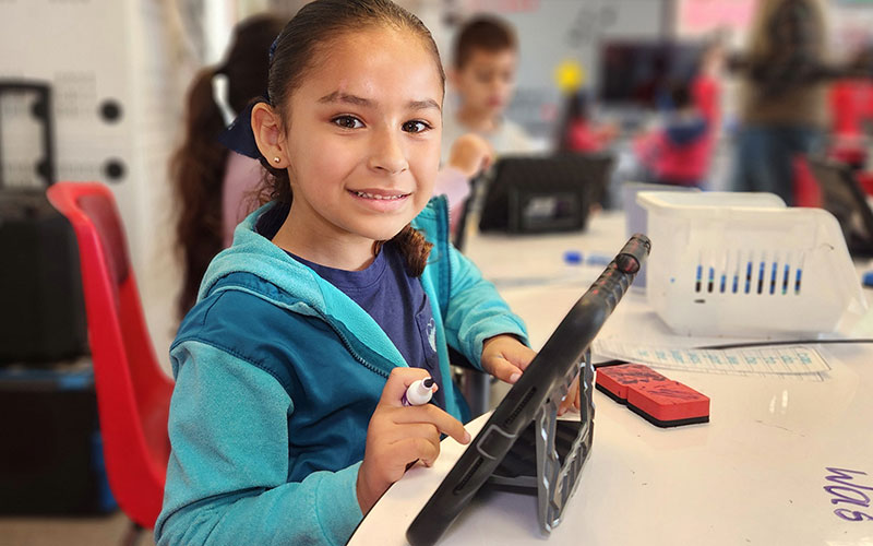 little girl on an ipad