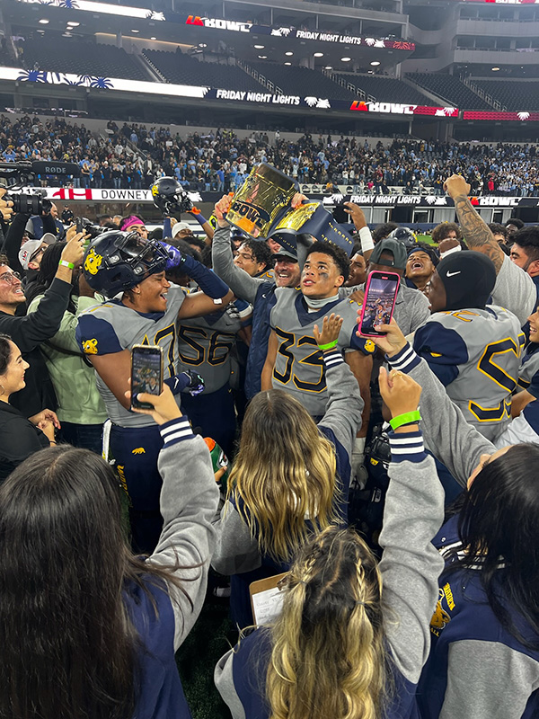 Warren high school football players celebrating winning the LA Bowl.