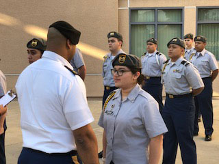 JROTC students in uniform standing at attention