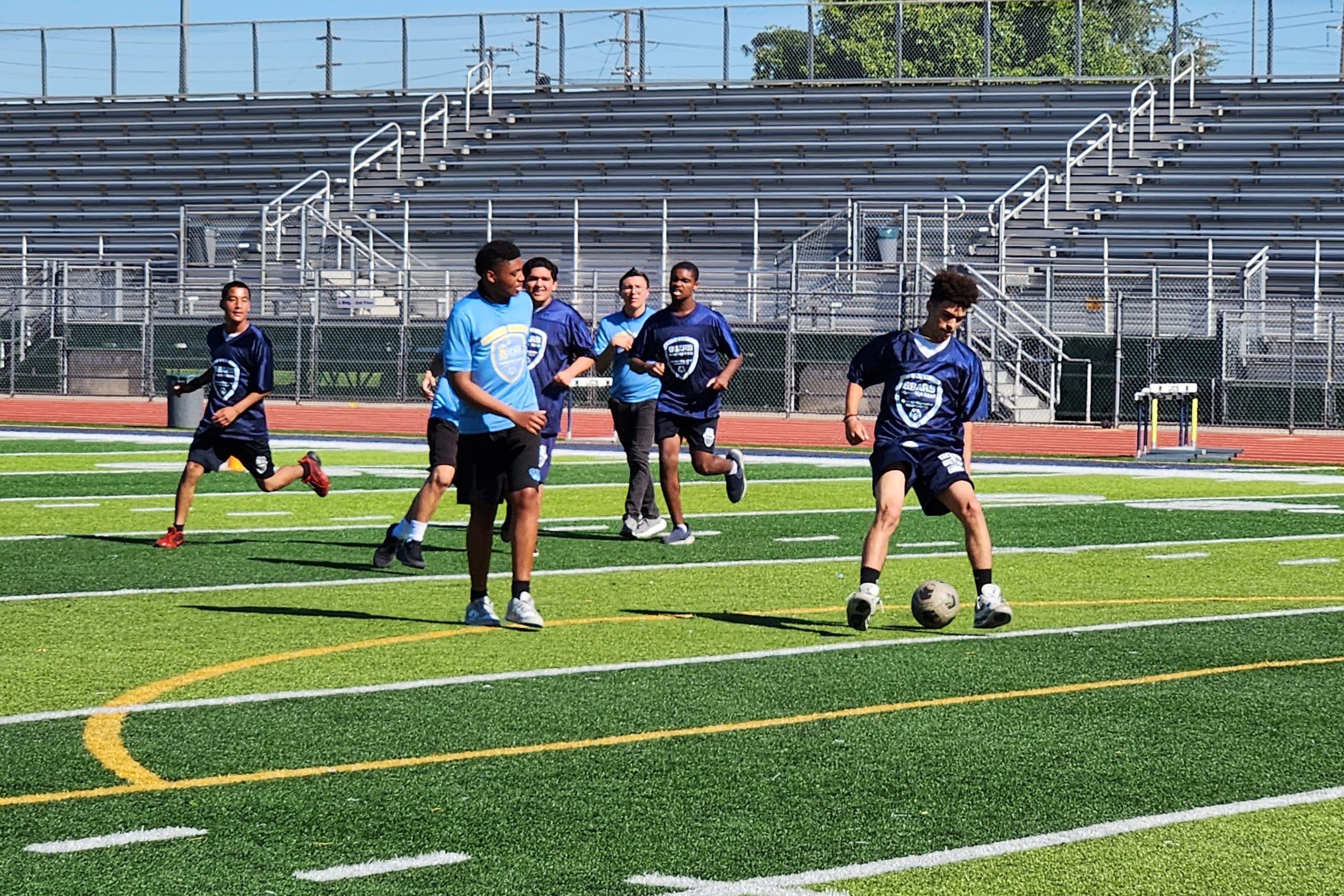 Warren High School Unified Soccer players competing during a game on the school’s athletic field.